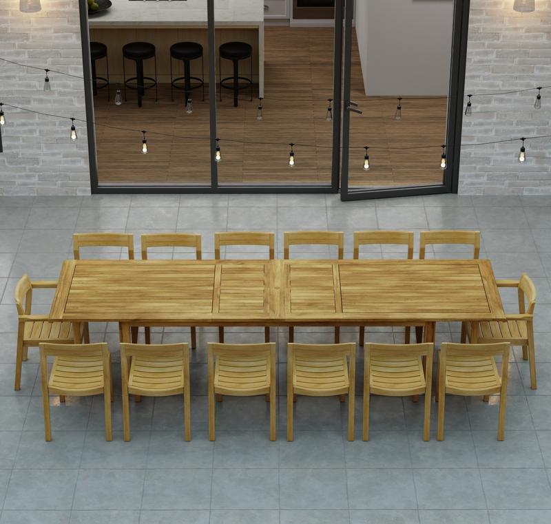alt="70353 Laguna 15 pc Teak Dining Set of 14 dining armchair and rectangular 11 foot extendable dining table angled aerial view in front of glass doors in the background "