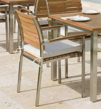 alt="22007 Vogue Stacking Armchair with optional seat cushion right angled view on concrete patio"