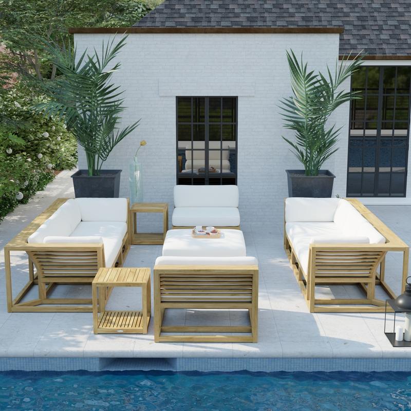 alt="70753 Maya 7 pc Twin Sofa Set angled on pool deck behind a pool with a potted plants and house in the background"
