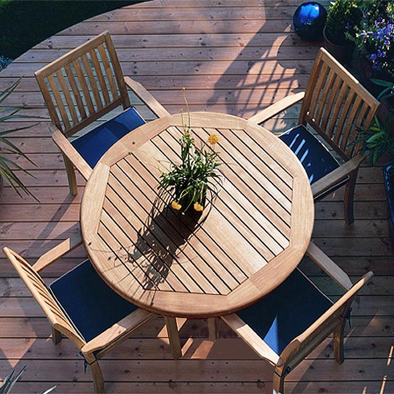 alt="70033 Sussex Barbuda 5 piece Dining Set with optional seat cushions overhead view with potted flowering plant on center of table top on curved wooden deck with plants in background"