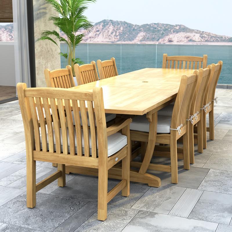 alt="70792 Veranda 9 pc Teak Dining Set of Veranda Rectangular Extending Dining Table and 2 Dining Arm Chairs and 6 Side Chairs with optional seat cushions and a potted plant and ocean view background"