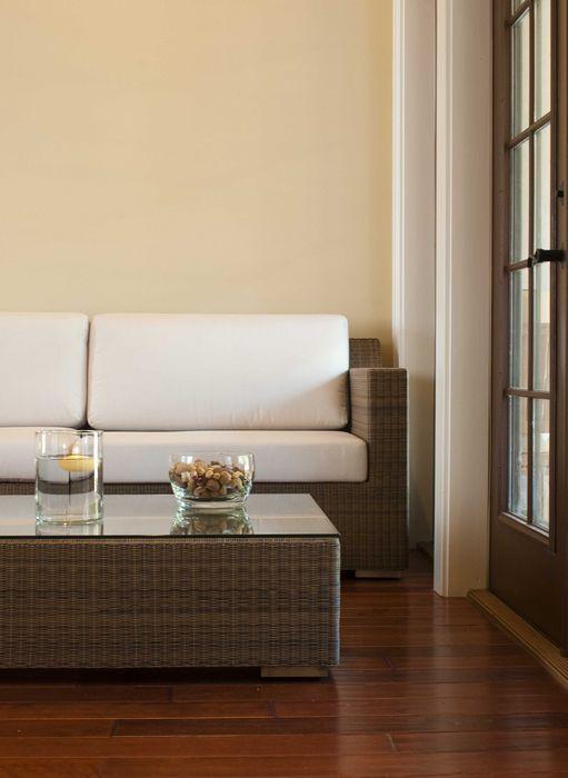 alt="31004 malaga synthetic wicker left side sectional front view on wood floors bowl and floating candle on table indoor setting  "