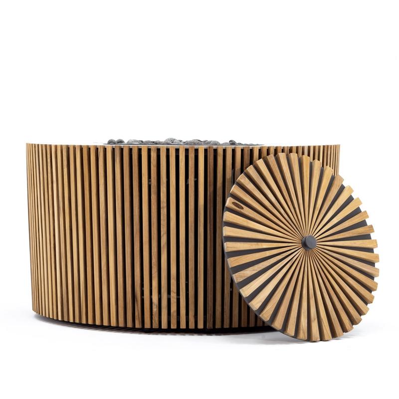 alt="14100 Agora Round 40 inch table side view showing slatted teak exterior with teak fire bowl cover leaning against fire table on white background "