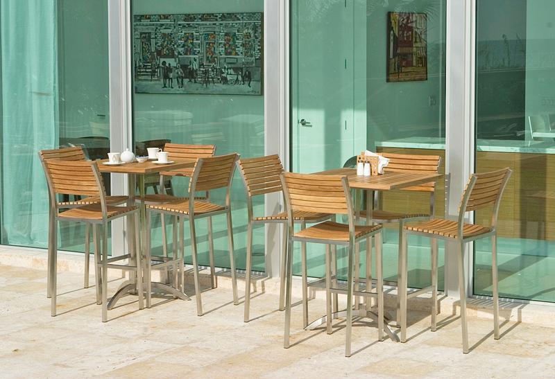 alt="25313 Vogue High Bar Set showing salt and pepper napkins holder teapot and 3 cups sugar bowl on concrete patio with glass sliding doors interior room 2 paintings view in background"
