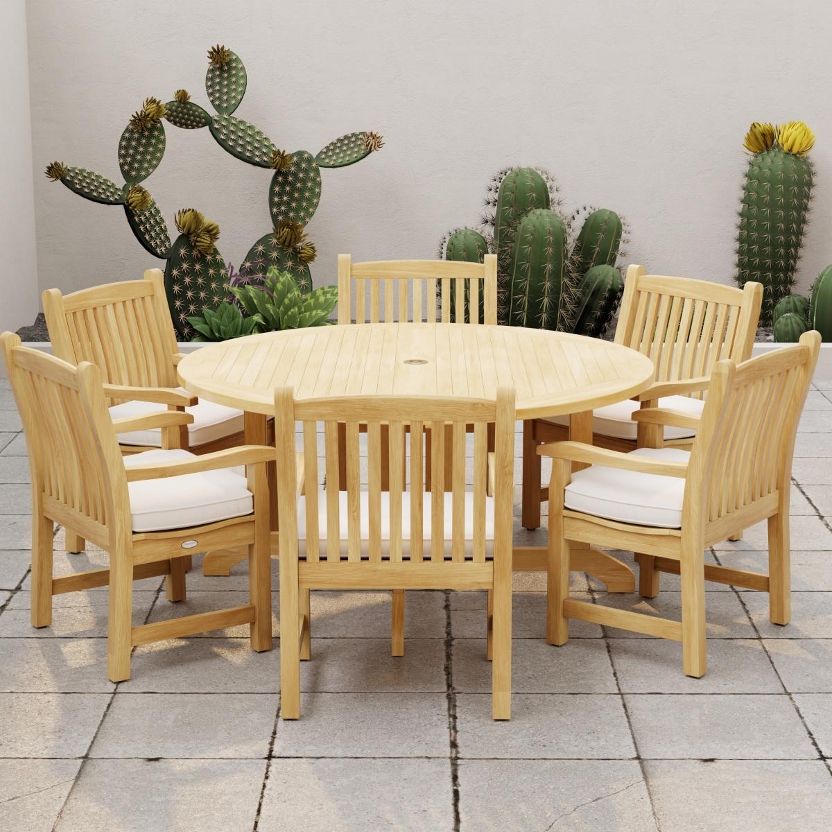 70350 Barbuda Veranda 7 pc Dining Set with optional seat cushions angled side view on stone patio with cactus plants against a privacy wall in the background