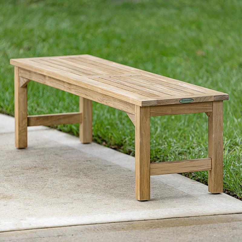alt="13929 Veranda teak 5 foot long Backless Bench angled end view on concrete walkway with grass in background"