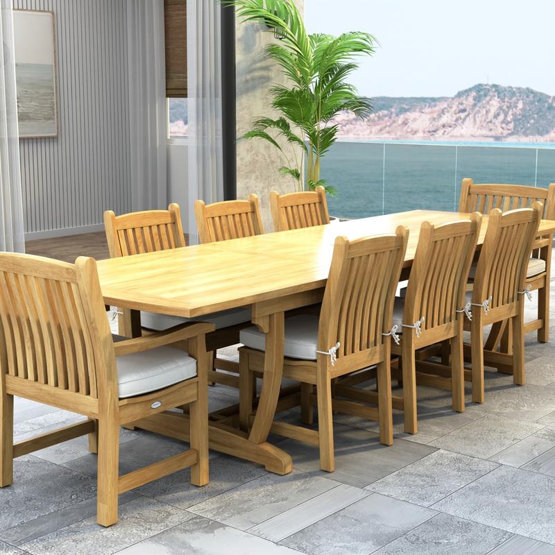 alt="70792 Veranda 9 pc Teak Dining Set of Veranda Rectangular Extending Dining Table and 2 Dining Arm Chairs and 6 Side Chairs with optional seat cushions and a potted plant and ocean view background"