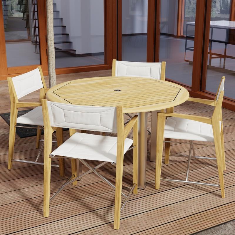 alt="70619 Vogue Odyssey 5 pc Round Dining Set of Vogue Dining Table and 4 Odyssey Folding Chairs angled top view on patio with glass doors in the background "