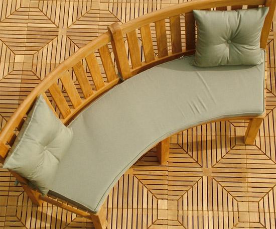 alt="71000MTO Solid Color Throw Pillow two in stone green color top view on cushioned curved teak bench with back on teak tiled floor"