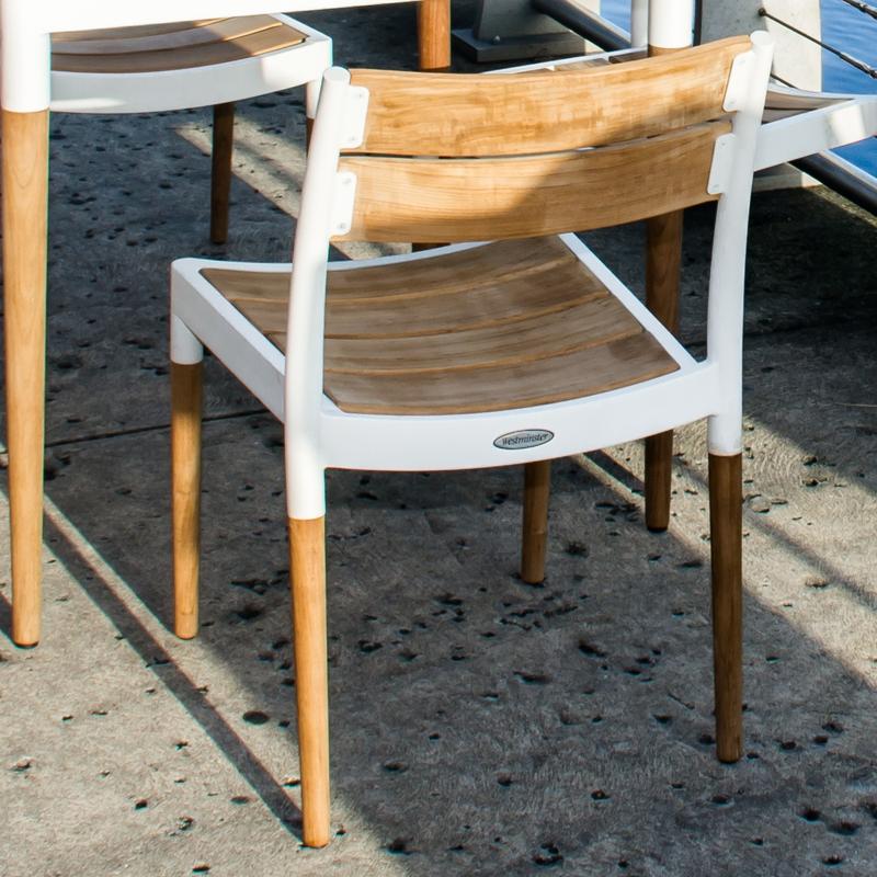 alt="70591 Bloom teak and powder coated aluminum side chair angled rear view on wooden dock with marina background"