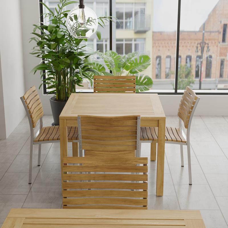 alt="70426 Vogue 5 piece Cafe Set of Bistro Teak 36" Square Dining Table and 4 Vogue teak and stainless steel side chairs in side view with tall windows and potted plants in background"