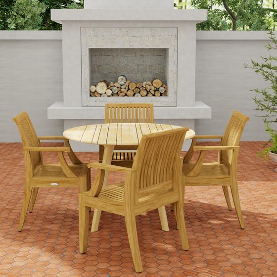 70544 Laguna & Surf 5 pc Dining Set of Surf Folding 42 inch Round Table and 4 Laguna Dining Armchairs in side view on a patio with outdoor fireplace in background