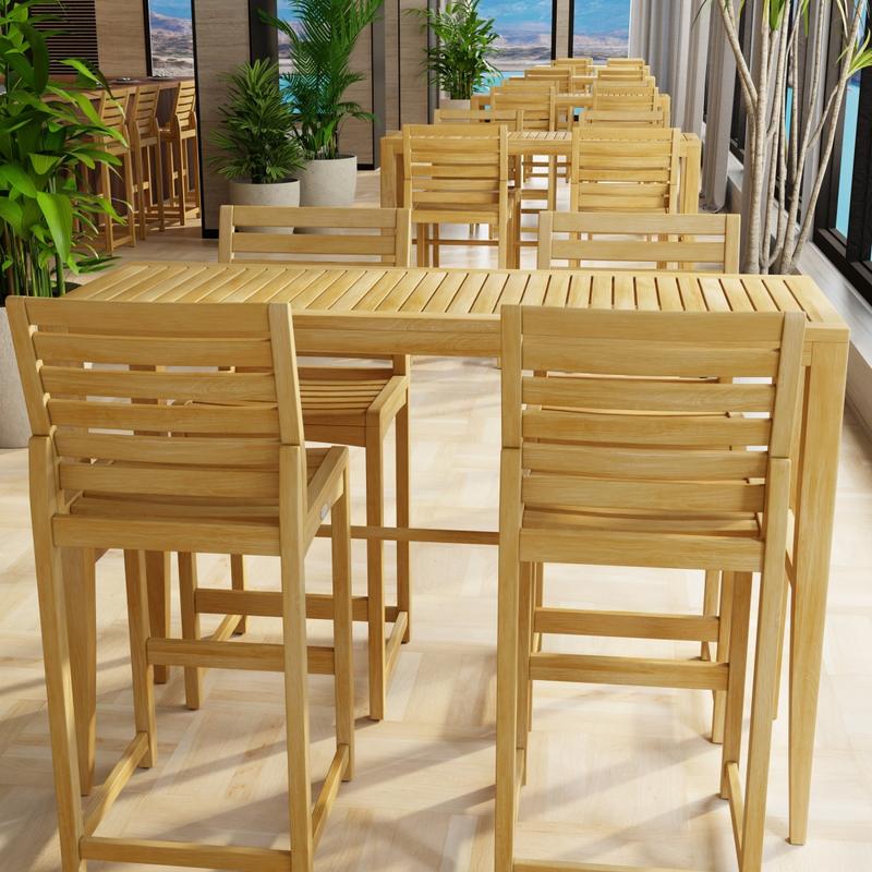 alt="70649 Laguna Somerset Side Barstool Set in a hospitality setting showing 4 sets in side view surrounded by potted plants next to a wall of windows overlooking the ocean"