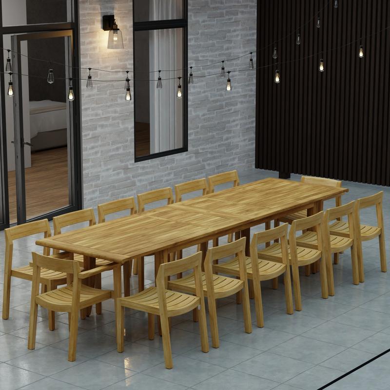 alt="70353 Laguna 15 pc Teak Dining Set on tiled patio in angled side view and hanging patio lights and glass door and privacy fence in background"