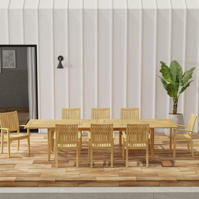 alt=" 70774 Laguna Sussex 9 pc Teak Dining Set with optional umbrella in side view on patio with potted tree and glass door of house in background"
