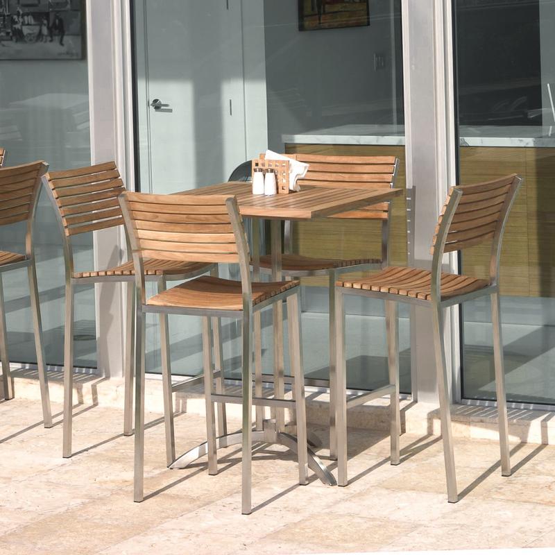 alt="70075 Vogue 5 piece square Bar Set on concrete patio with condiments and napkin holder on table with glass sliding doors in background"