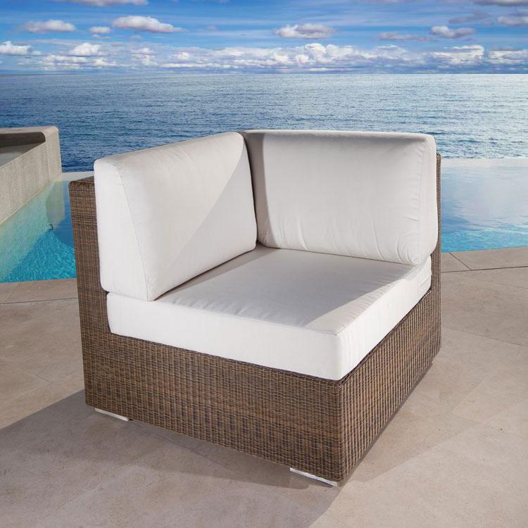alt="31002 malaga synthetic wicker deep seating corner sectional two back cushions and one corner seat cushion on pool deck with pool and ocean background"