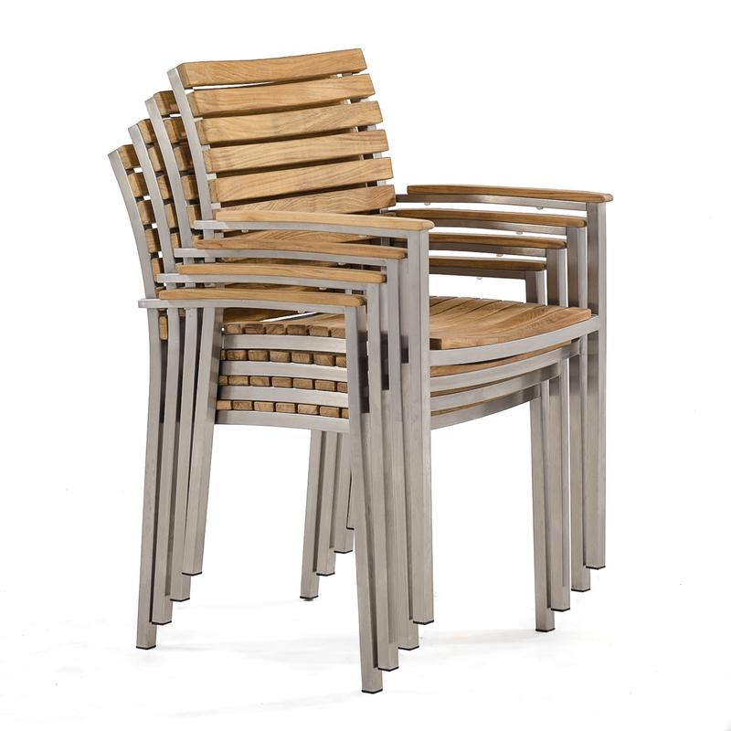 alt="70568 Vogue teak and stainless steel dining armchair stacked 4 high in angled right side view on white background"