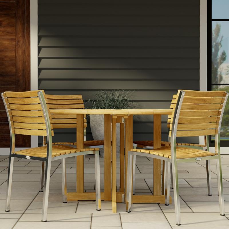 alt="70735 Barbuda Vogue 5 pc Teak DIning Set of Barbuda 48 inch Round Dining Table and 4 Vogue Teak and 304 Stainless Steel Side Chairs on tiled patio with house in the background"